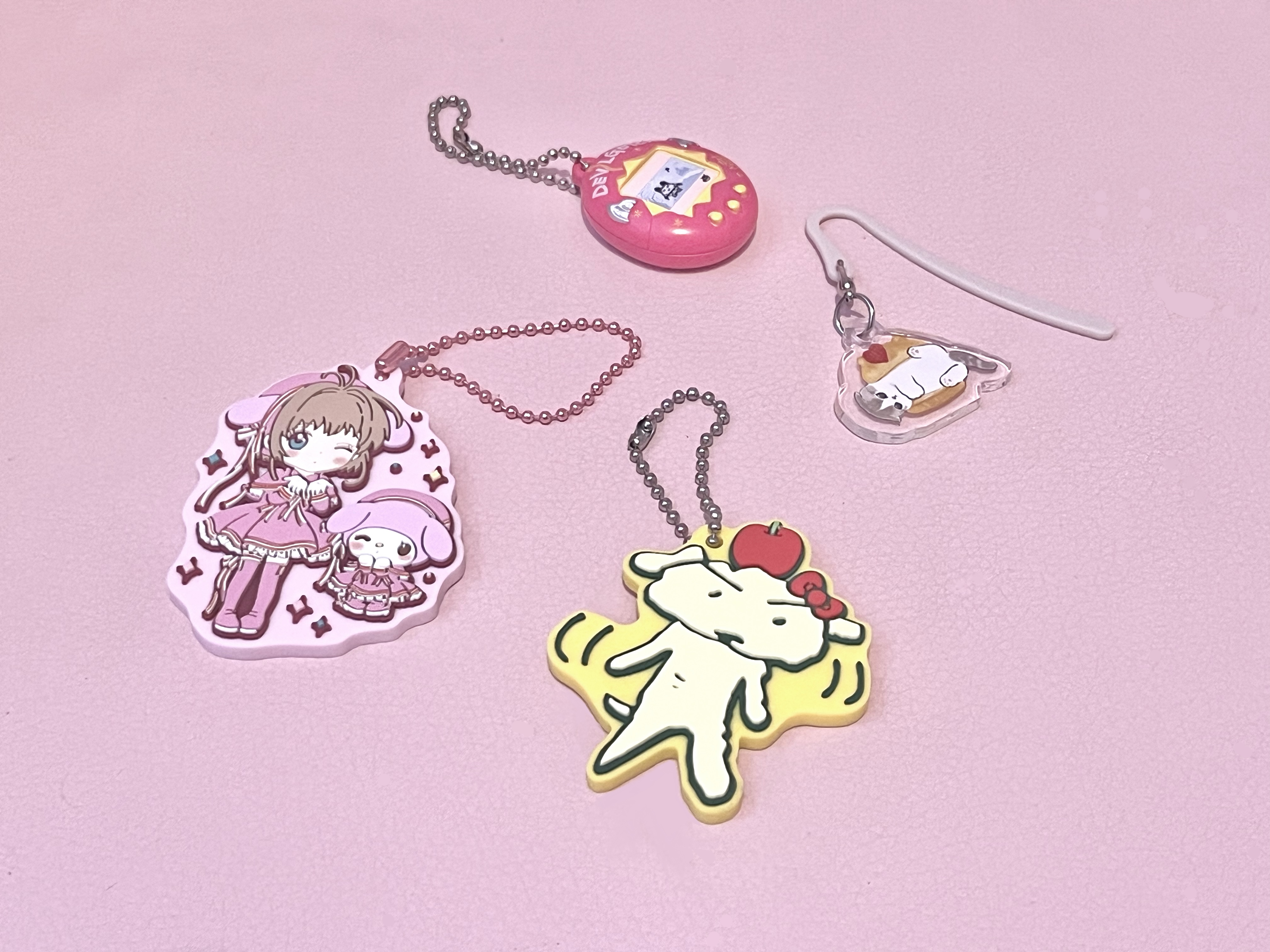 a bunch of cute keychains and a bookmark