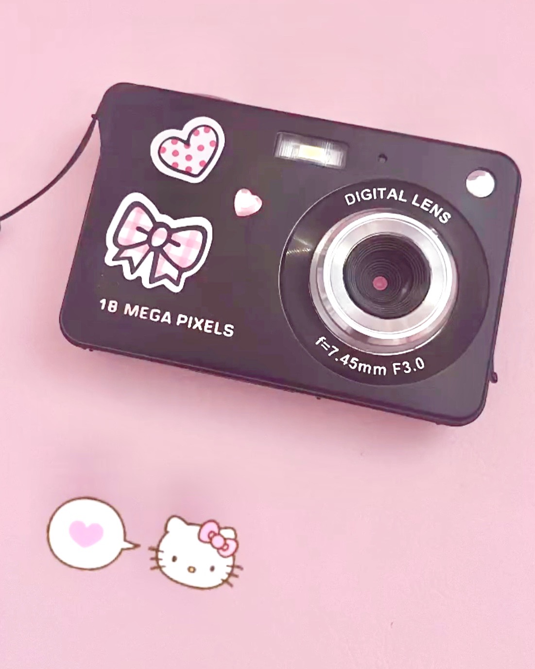 a black digital camera with pink stickers on it