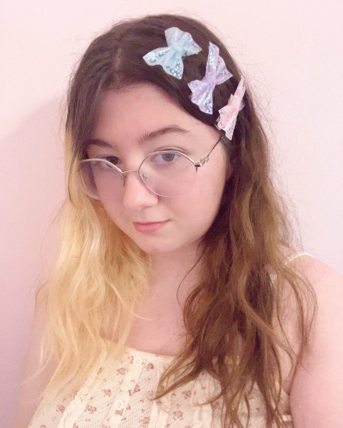 me, a girl with half brown half blonde hair and glasses, wearing 3 bows. one blue, one purple and one pink