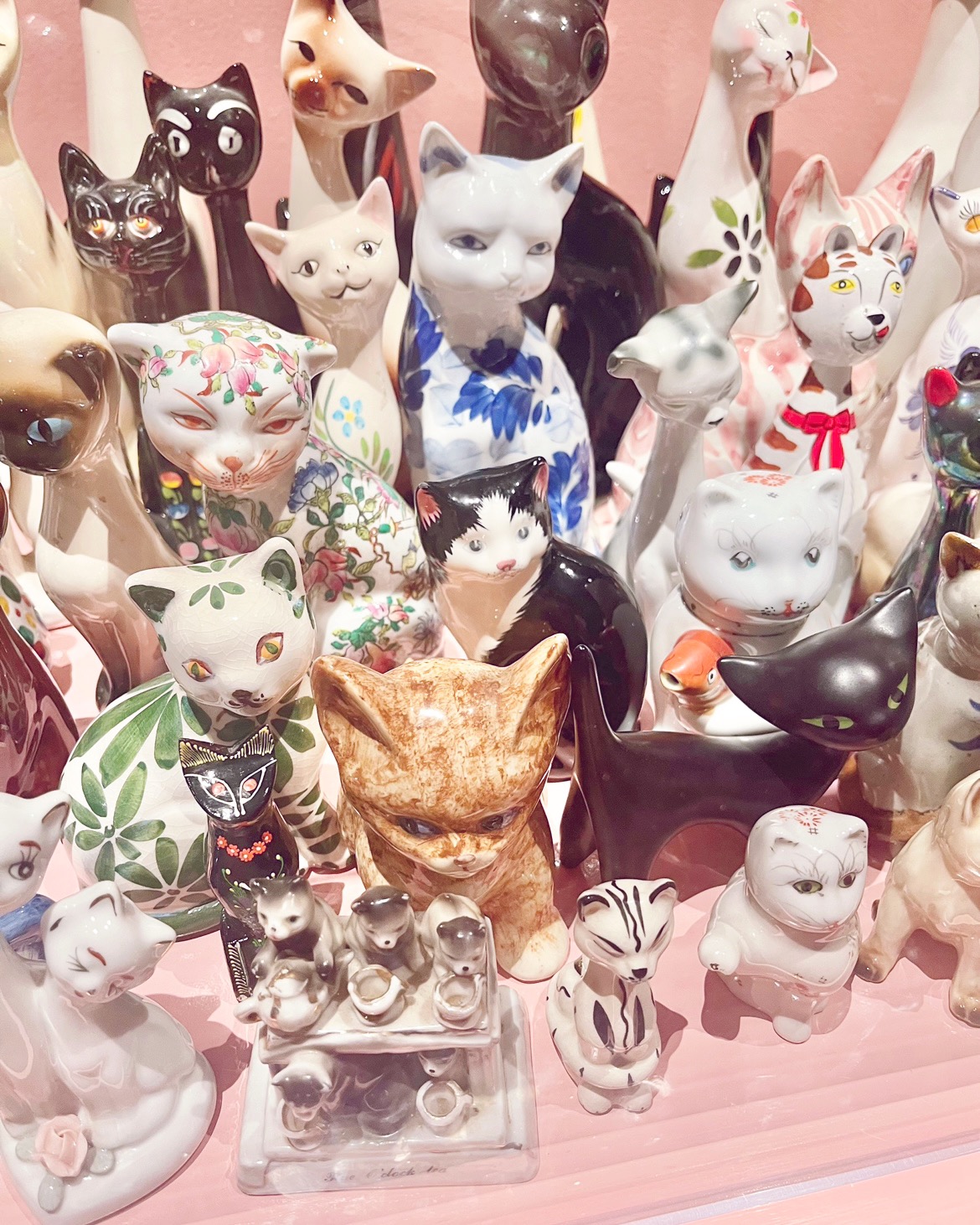 a bunch of ceramic cats